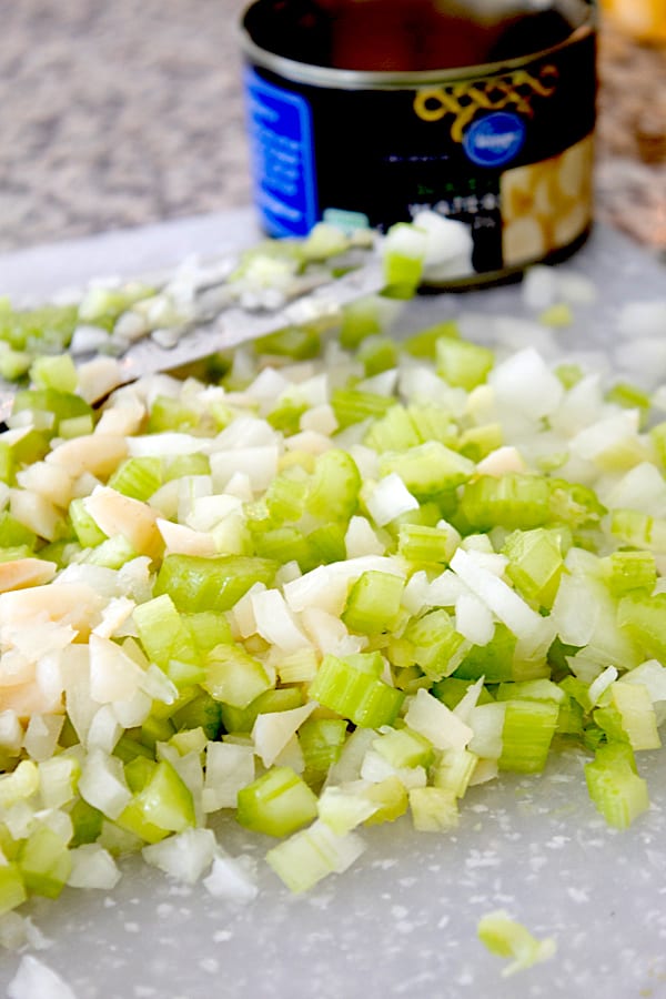 chopped celery onion and water chestnuts on a cutting board