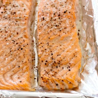 2 salmon filets cooked on a sheet pan with salt and pepper