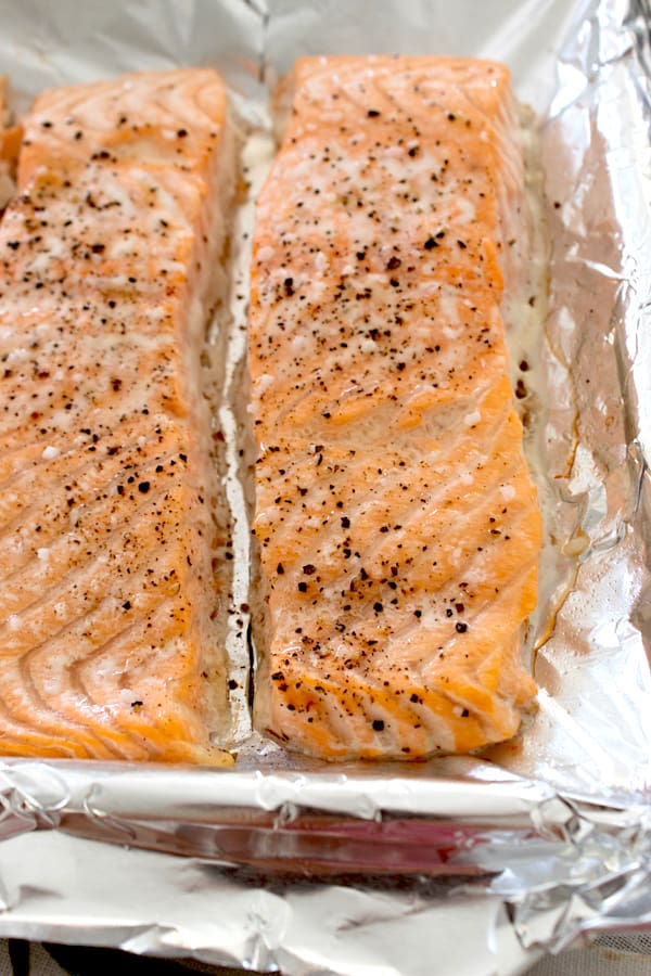 2 salmon filets cooked on a sheet pan with salt and pepper 