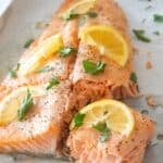 overhead view of salmon filet with lemon and parsley garnish