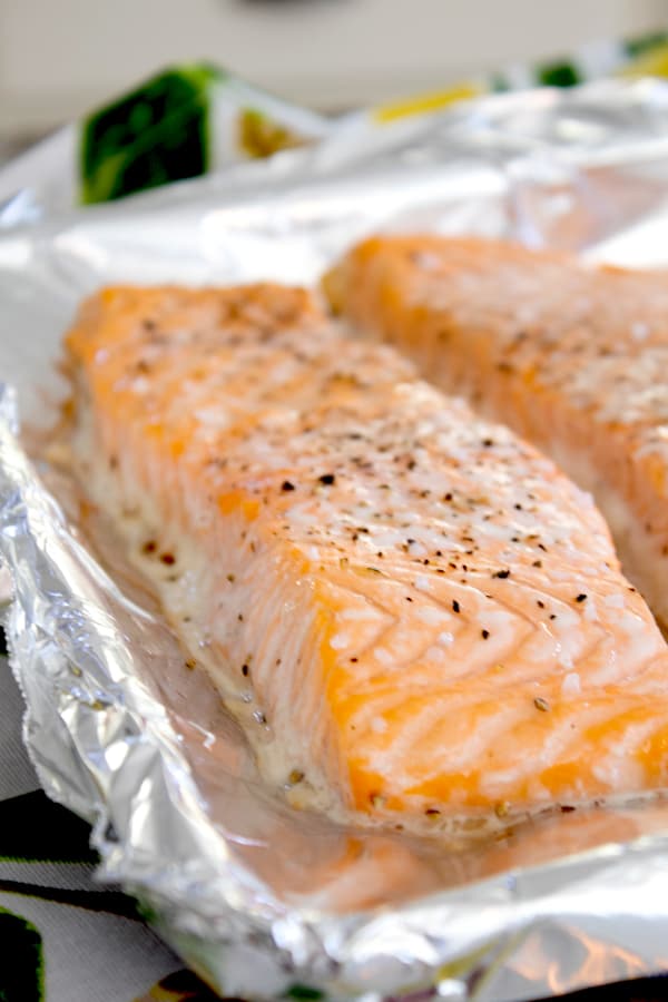 side view of cooked salmon filet on a sheet pan