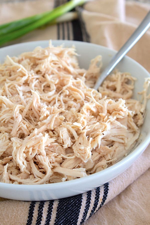 white bowl full of shredded chicken