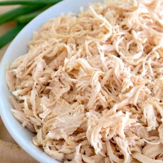 a white plate with shredded chicken on it