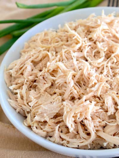 a white plate with shredded chicken on it