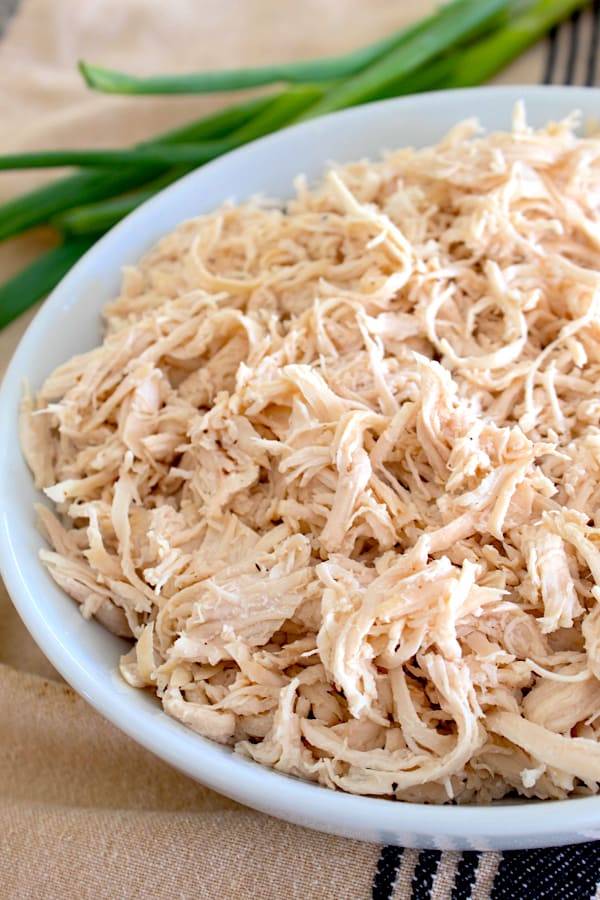 a white plate with shredded chicken on it