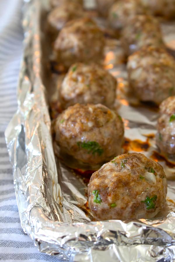 cooked meatballs on a sheet pan