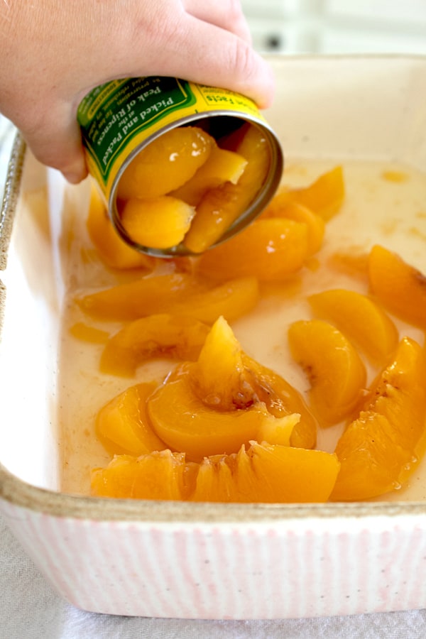 adding canned peaches to casserole dish