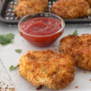 side view of air fryer chicken nuggets on a piece of parchment