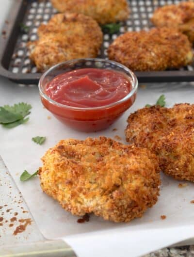 side view of air fryer chicken nuggets on a piece of parchment