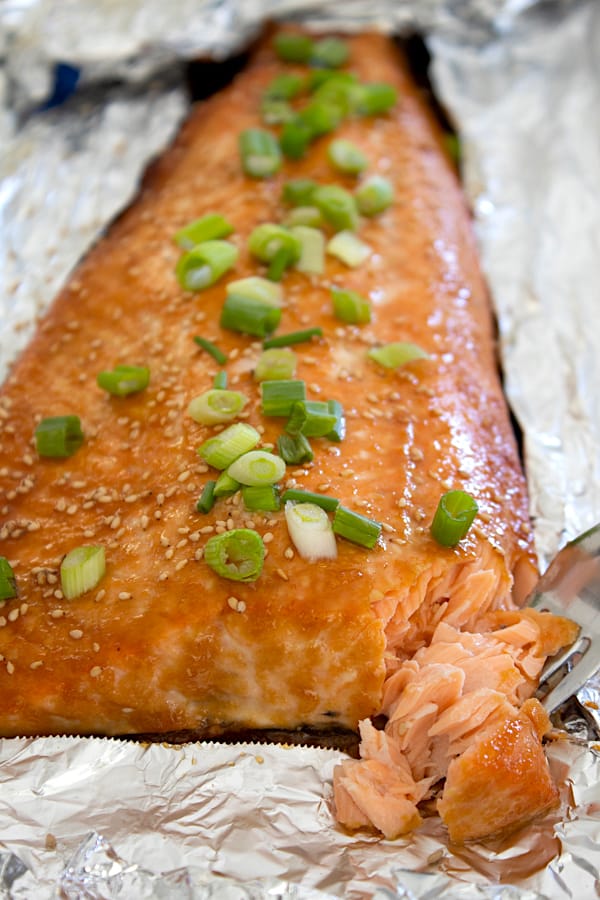 view of miso salmon on foil sheet pan with bite taken out