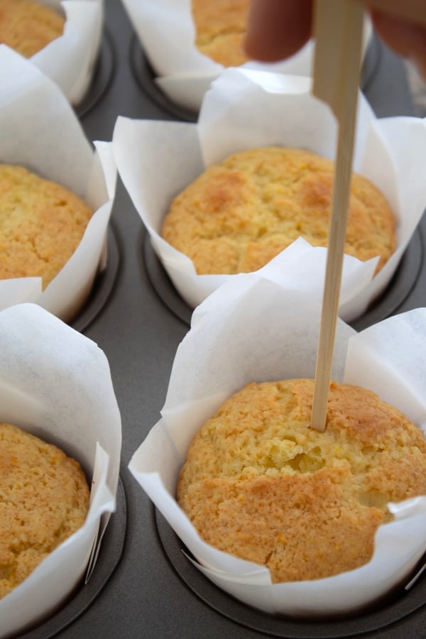 poking holes in orange muffins