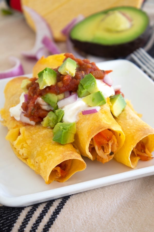 a plate of taquitos filled with chicken