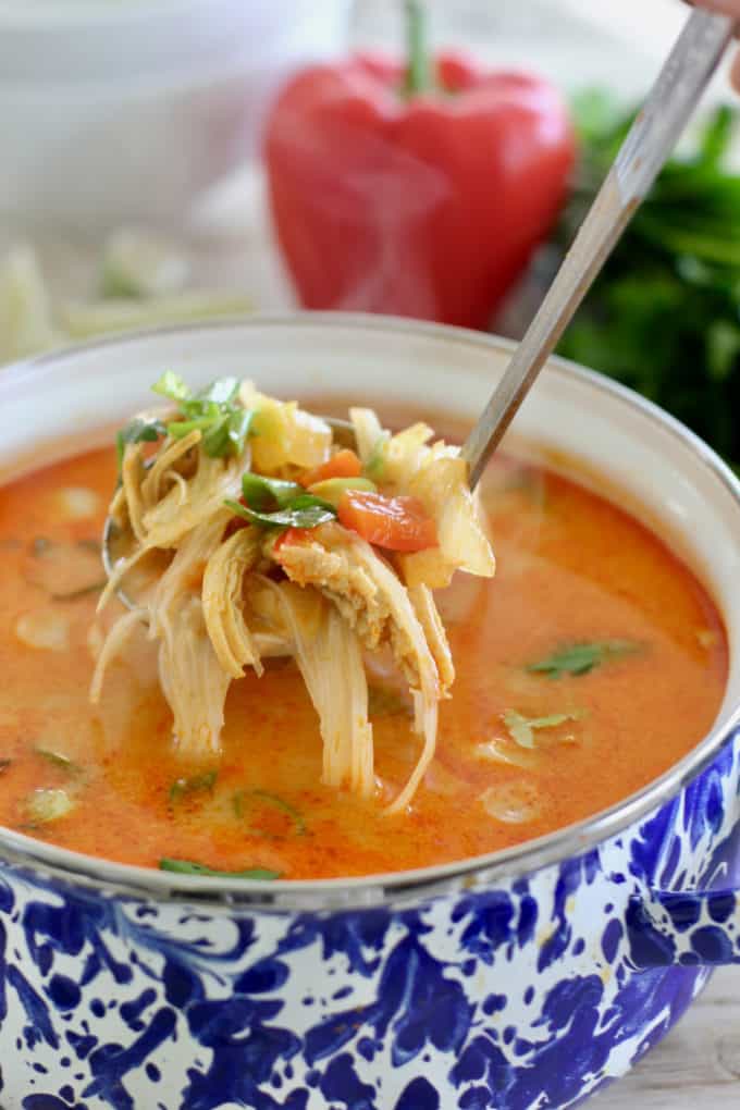 pot of asian soup being ladled into bowls