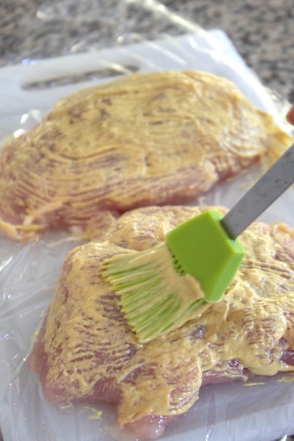 brushing turkey breast with dijon mixture