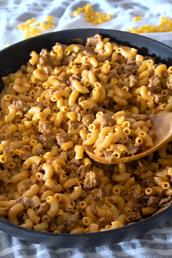 homemade hamburger helper in pan with wooden spoon