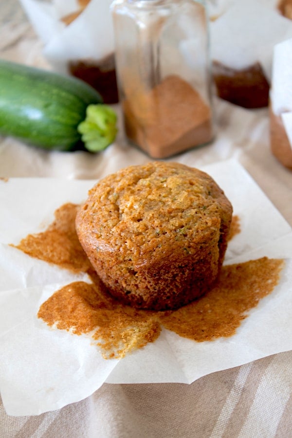 zucchini muffin peeled from liner on tea towel