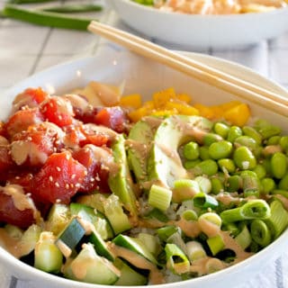 poke bowl with chopsticks with another poke bowl in background