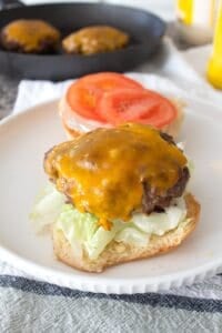 burger patty on an open face bun with condiments
