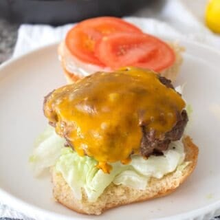 burger patty on an open face bun with condiments