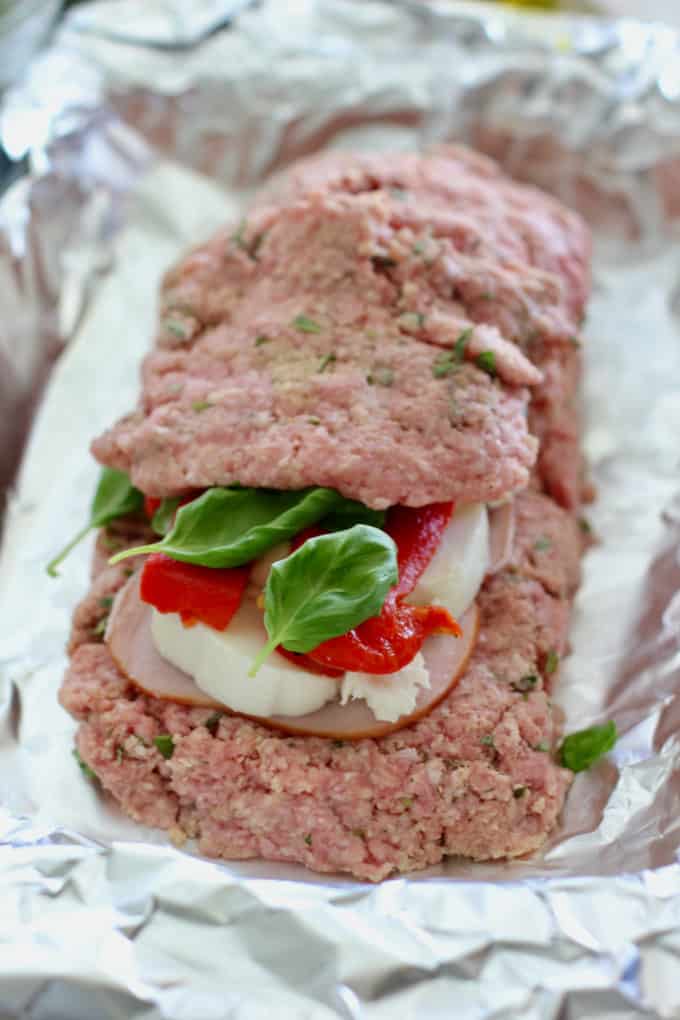top your stuffed meatloaf with remaining meat mixture