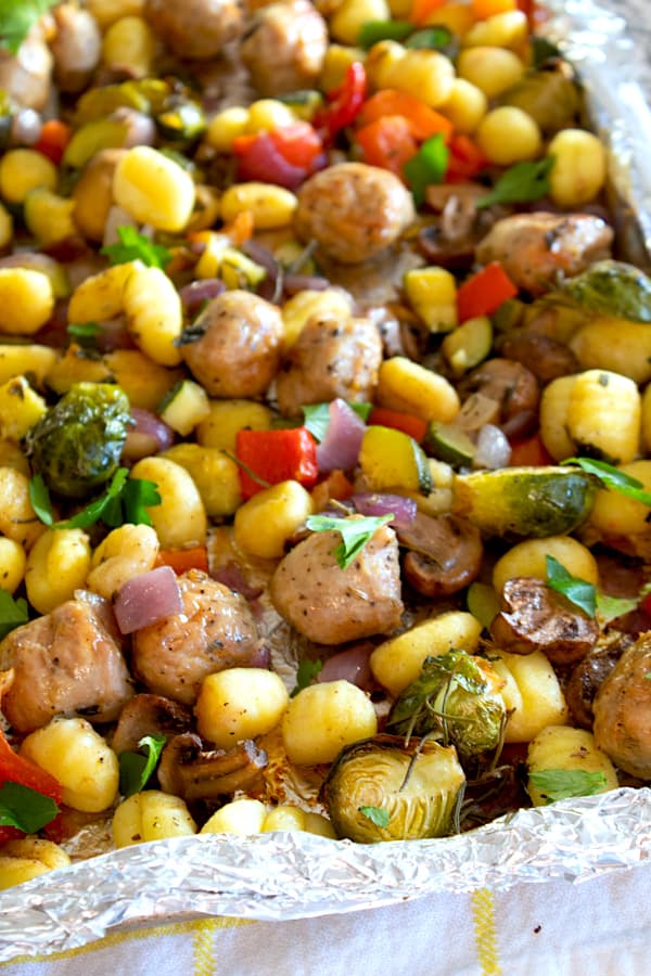 sheet pan of cooked gnocchi and vegetables with sausage 