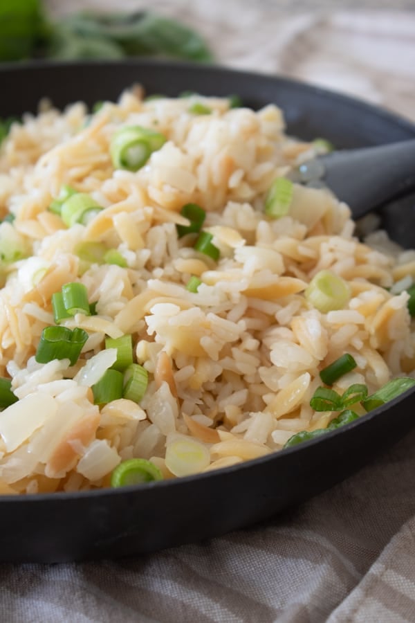 a black pan full of rice pilaf