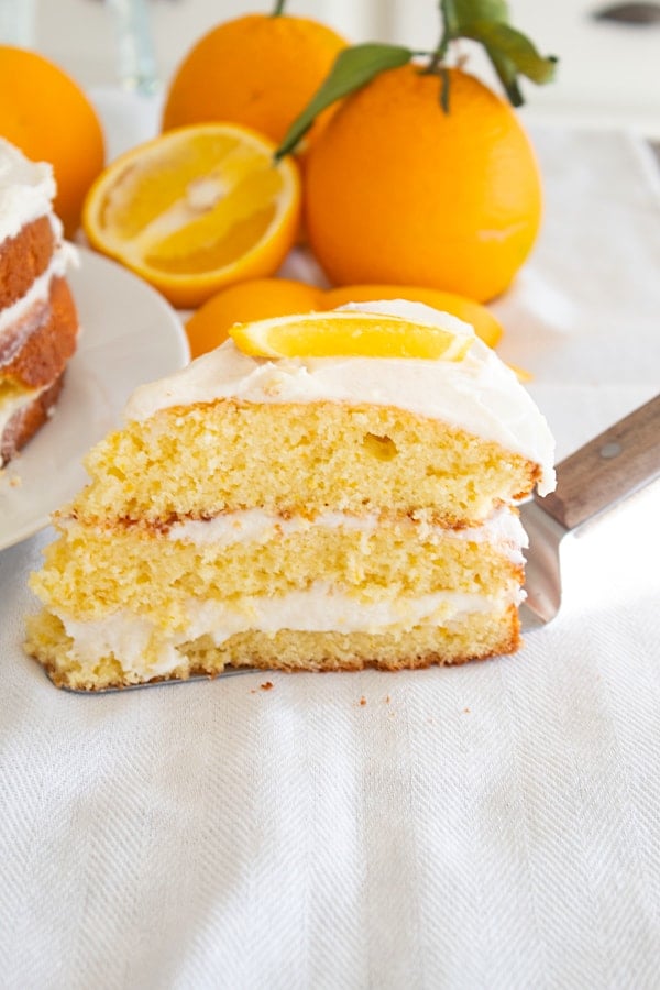 slice of orange cake on white tea towel