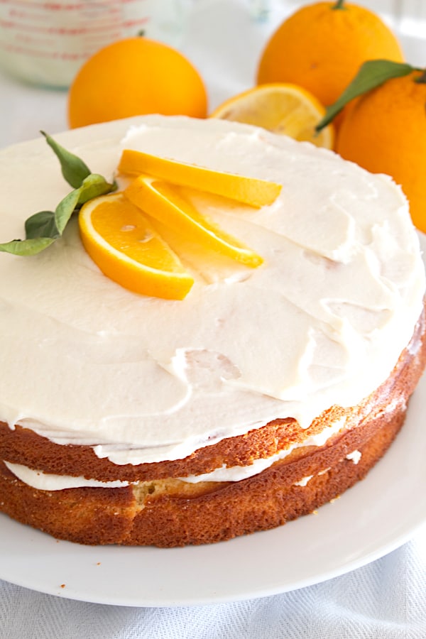3 layer orange cake with orange slice garnish