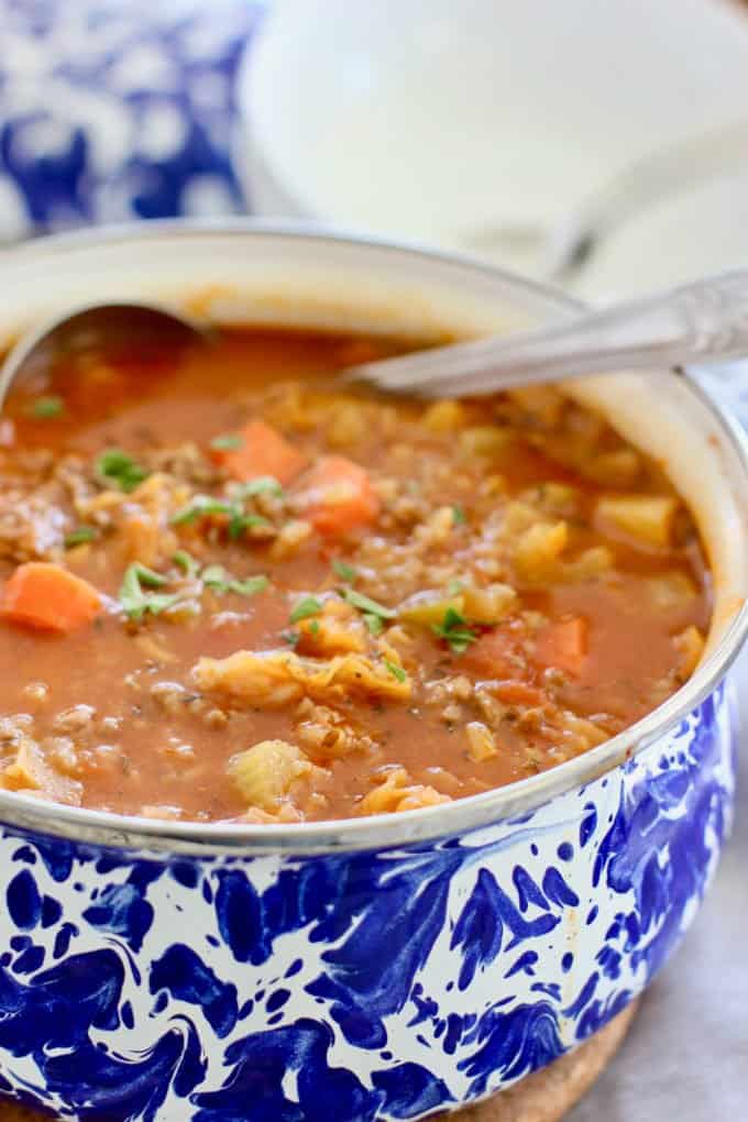 cabbage soup in a blue and white pot