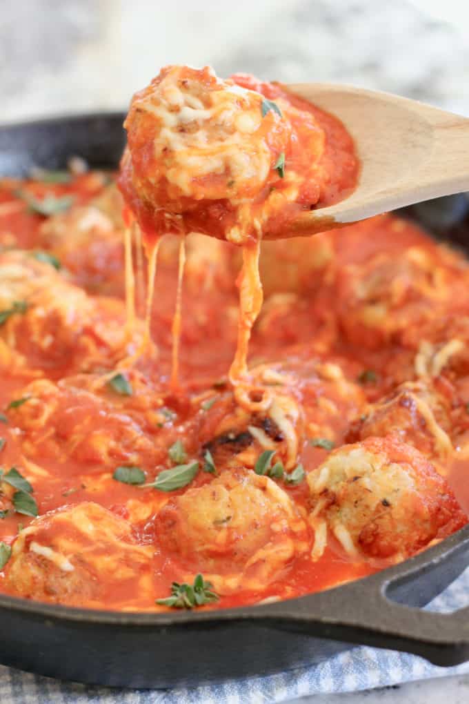 Ground chicken meatballs in tomato sauce in a skillet