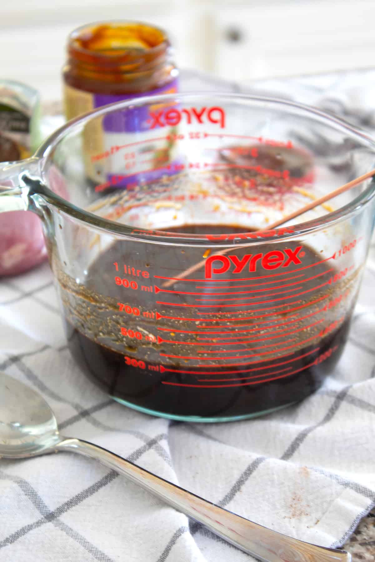 mixing pork marinade in a pyrex glass dish