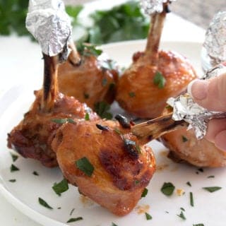 holding a chicken drumstick lollipop