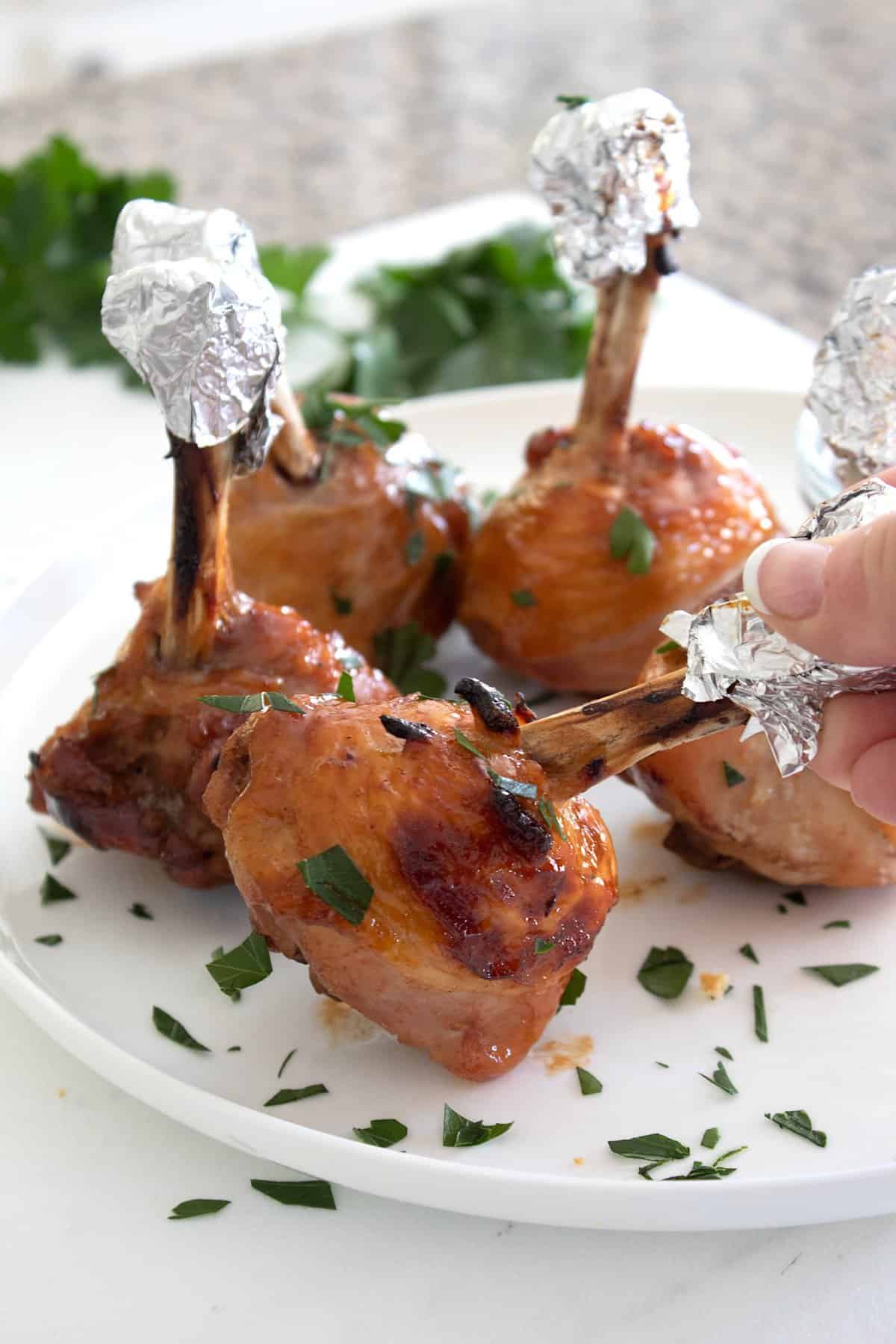 holding a chicken drumstick lollipop