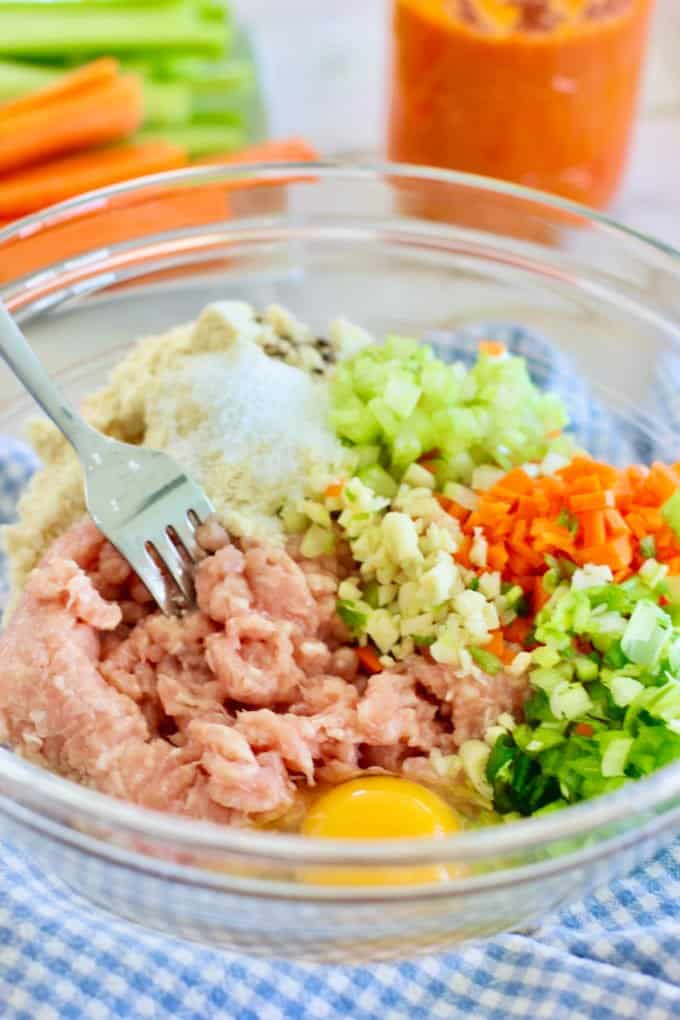 ingredients for meatballs in a large bowl