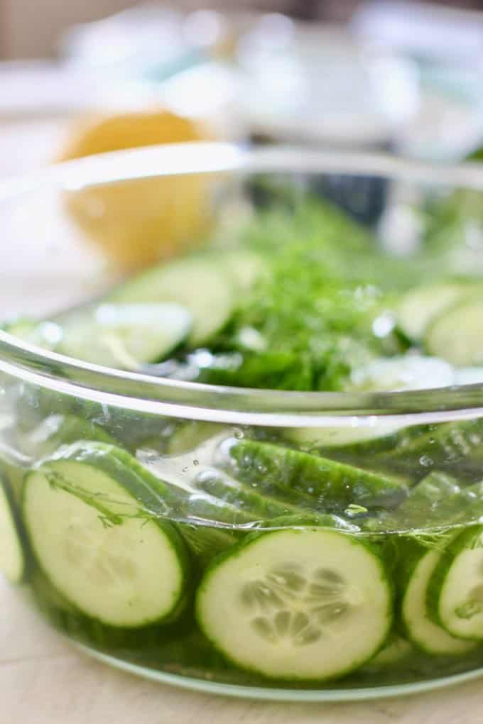 Pickled cucumbers in a clear bowl