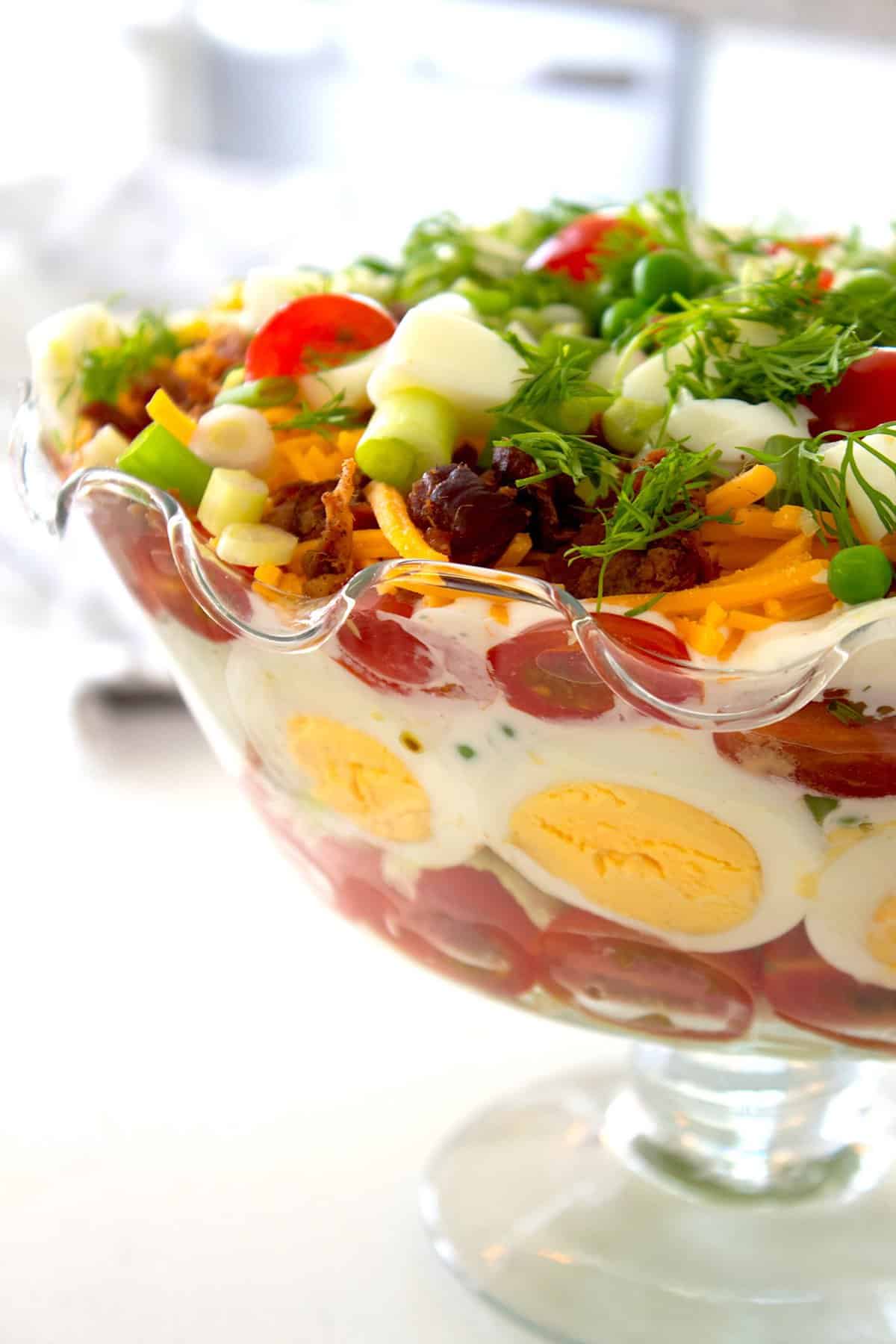 closeup of layered salad in a glass bowl