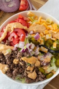 overhead view of cheeseburger salad in a white bowl