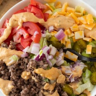 overhead view of cheeseburger salad in a white bowl