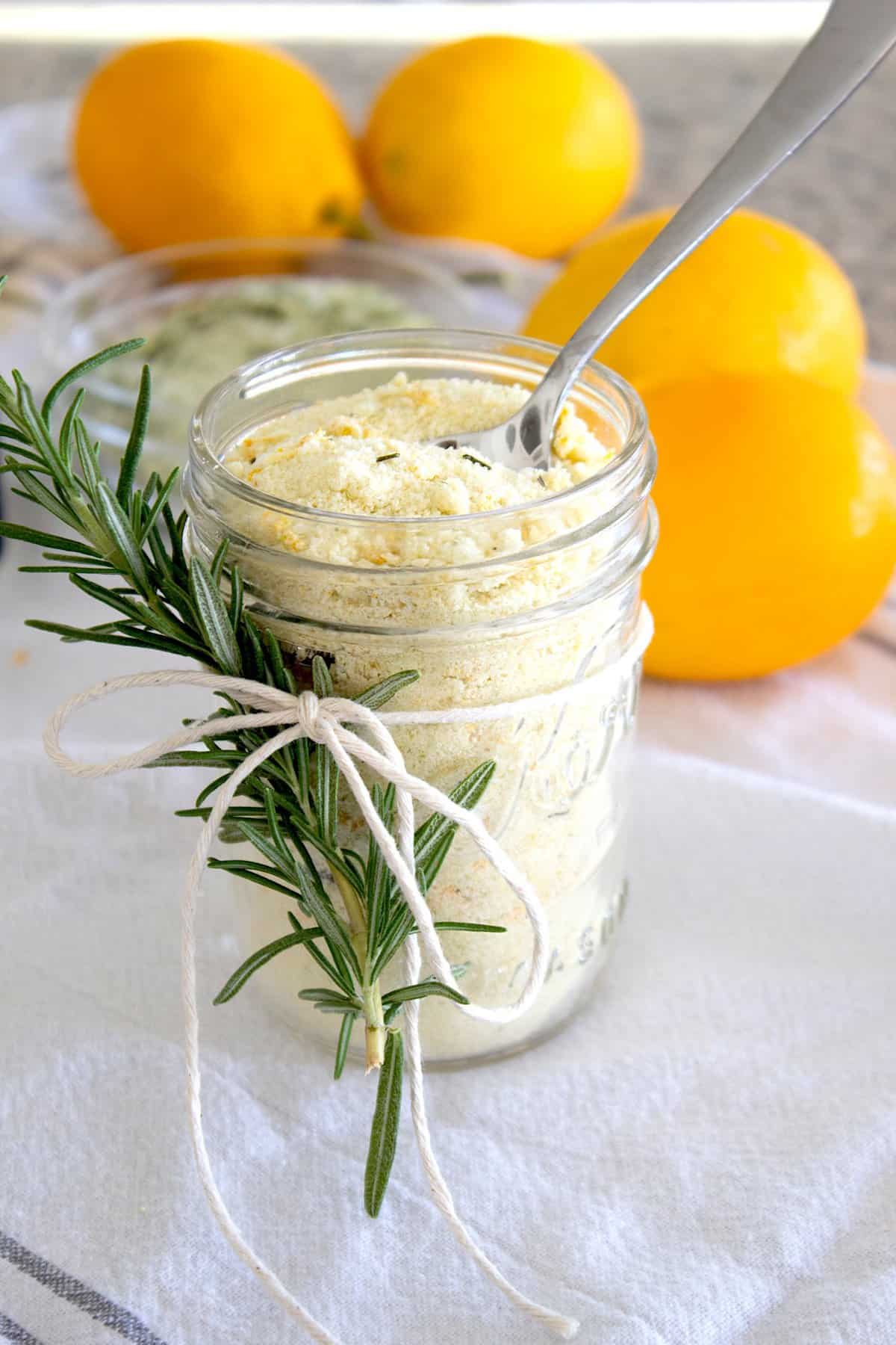 overhead view of mason jar filled with lemon salt with rosemary sprig garnish