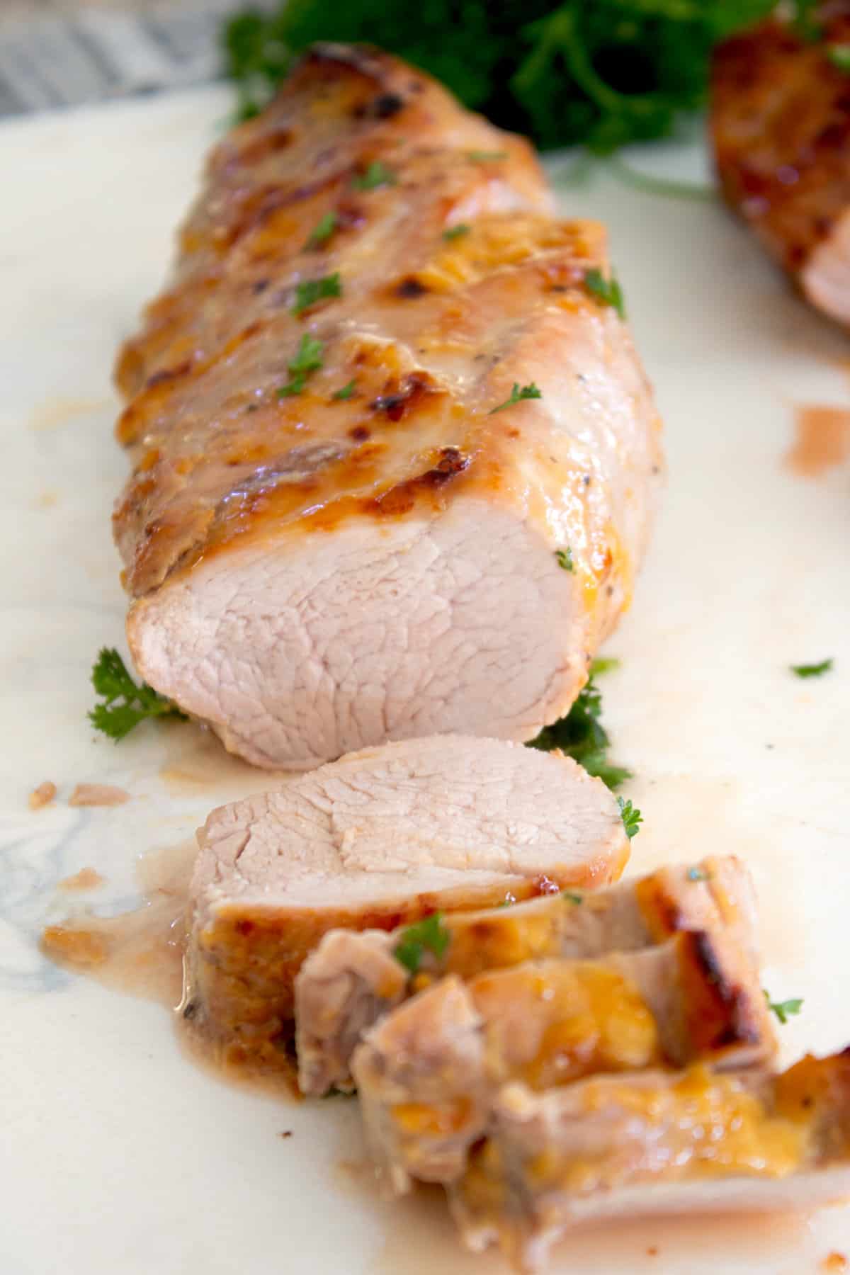 sliced pork tenderloin on a cutting board