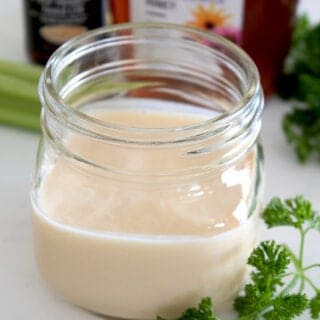 short mason jar full of creamy dressing