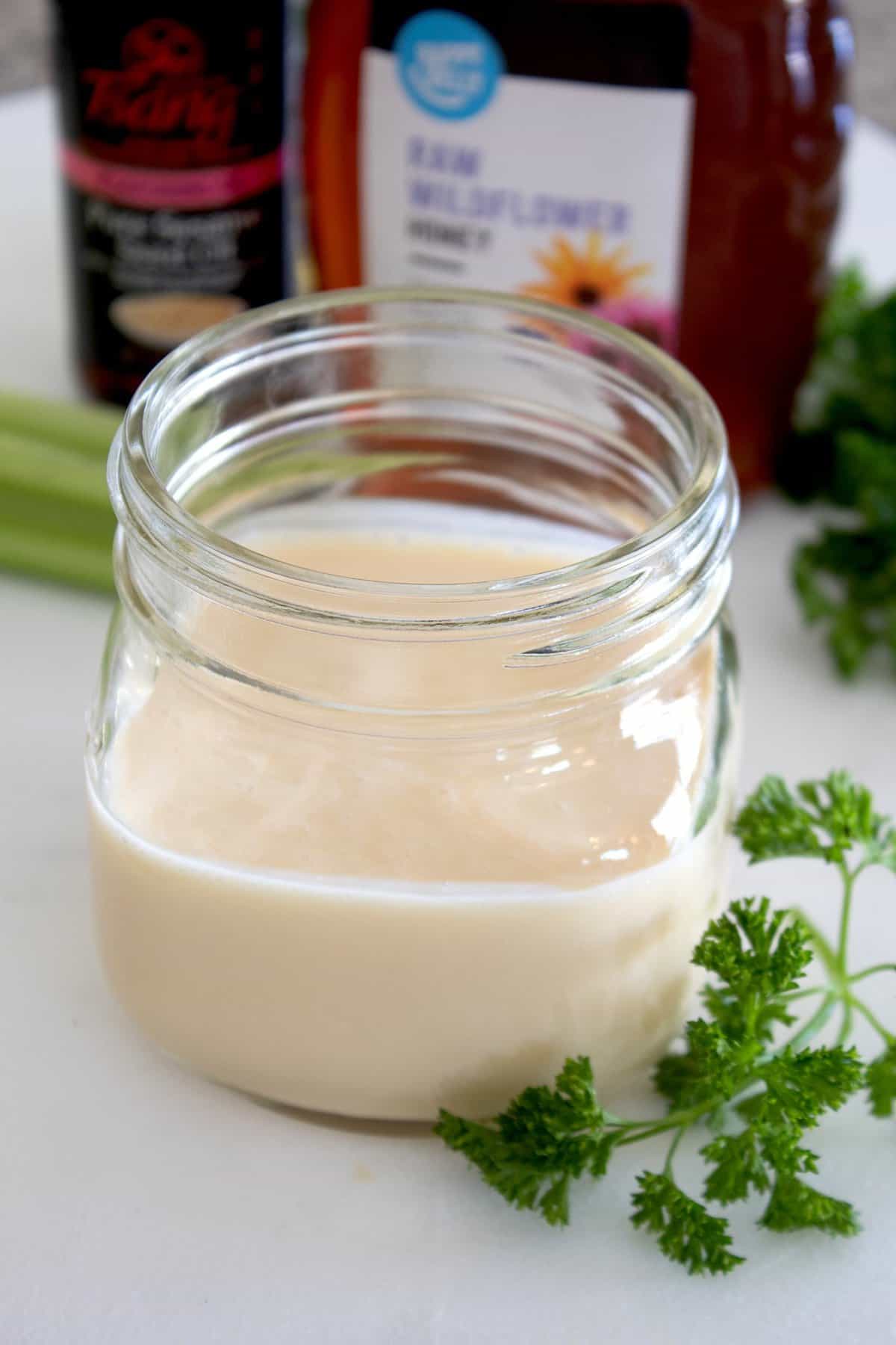 short mason jar full of creamy dressing