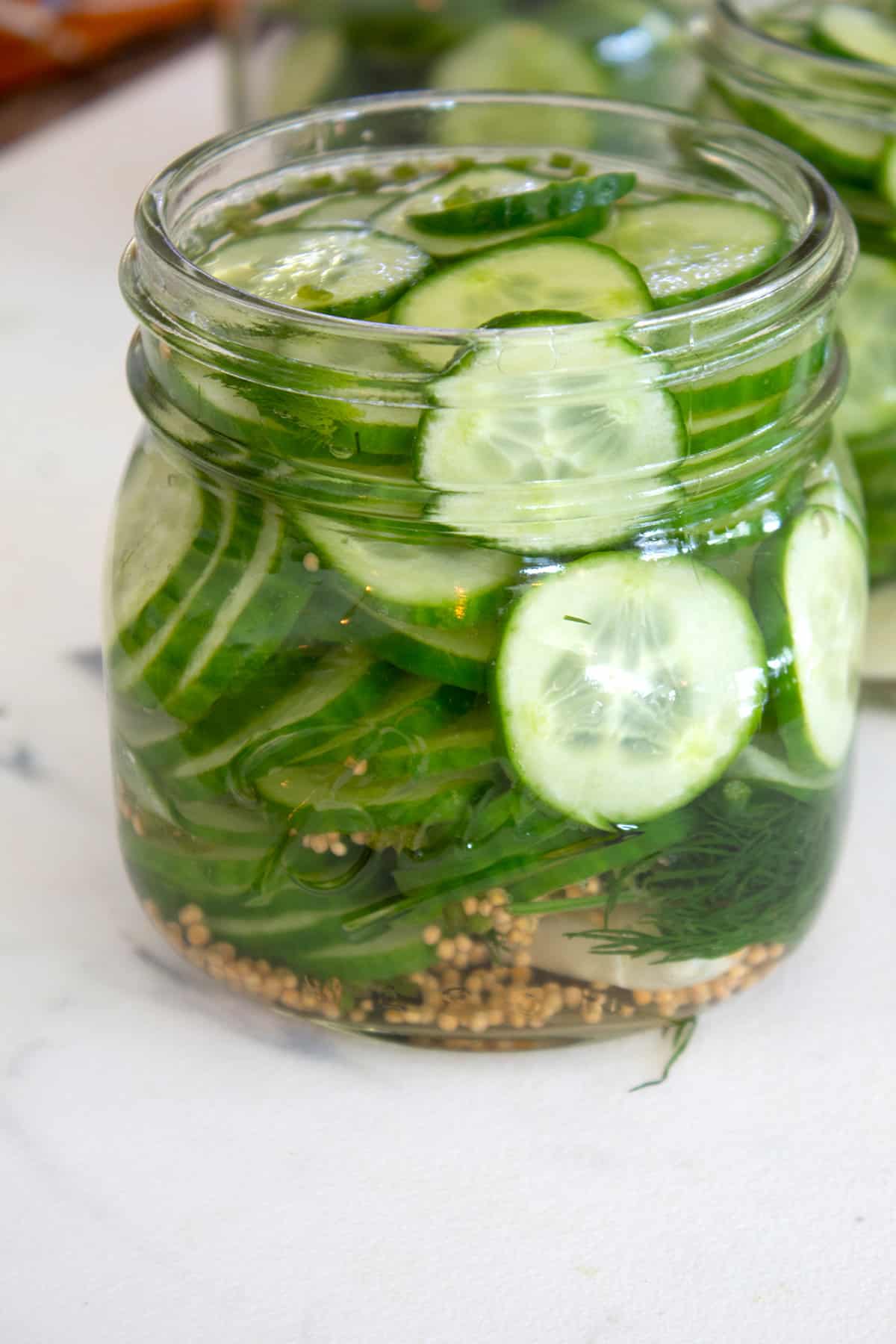 glass jar of pickles after pouring brine