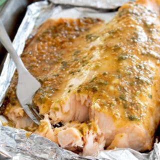 sheet pan with honey mustard salmon baked on it