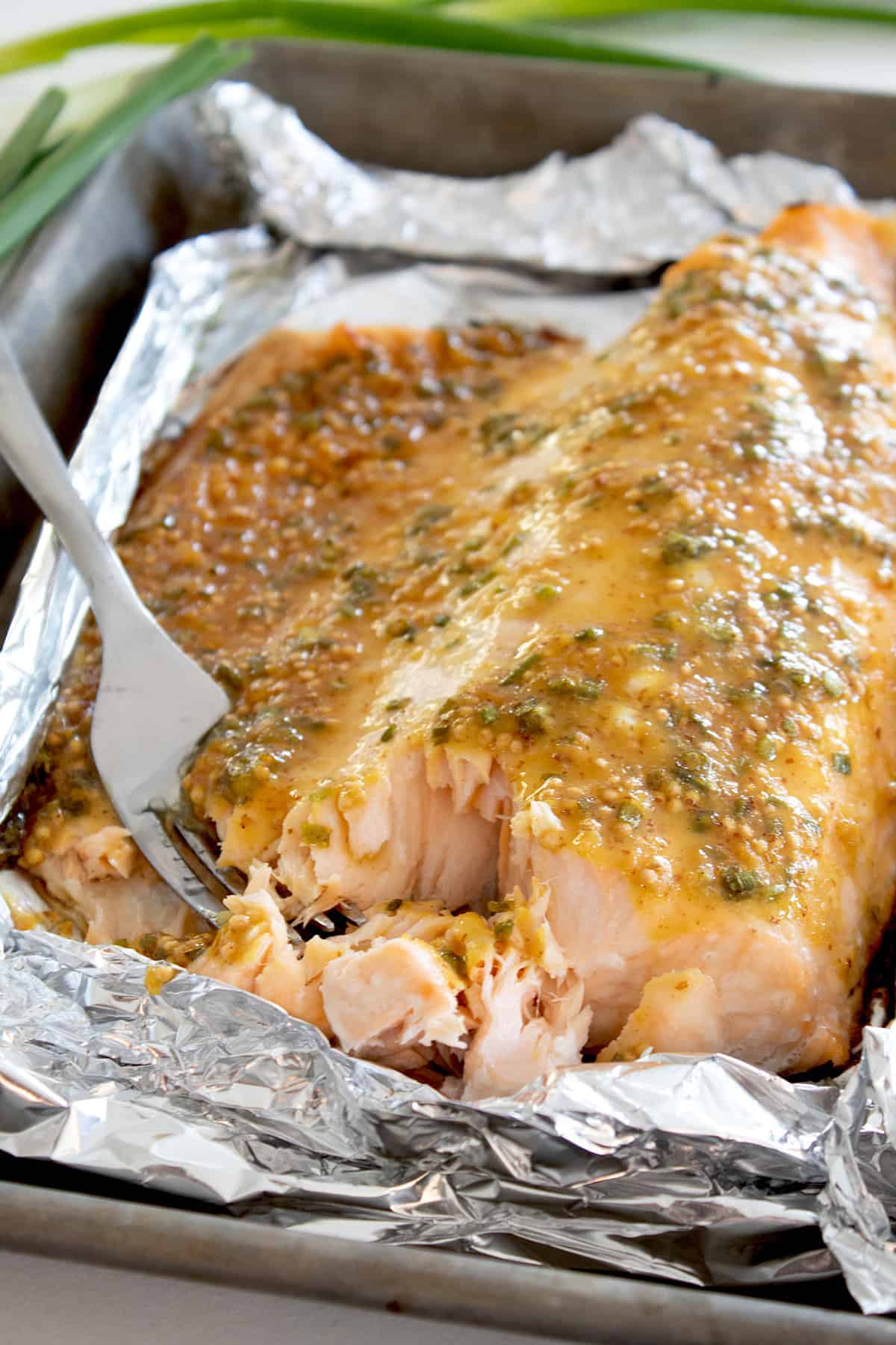 sheet pan with honey mustard salmon baked on it