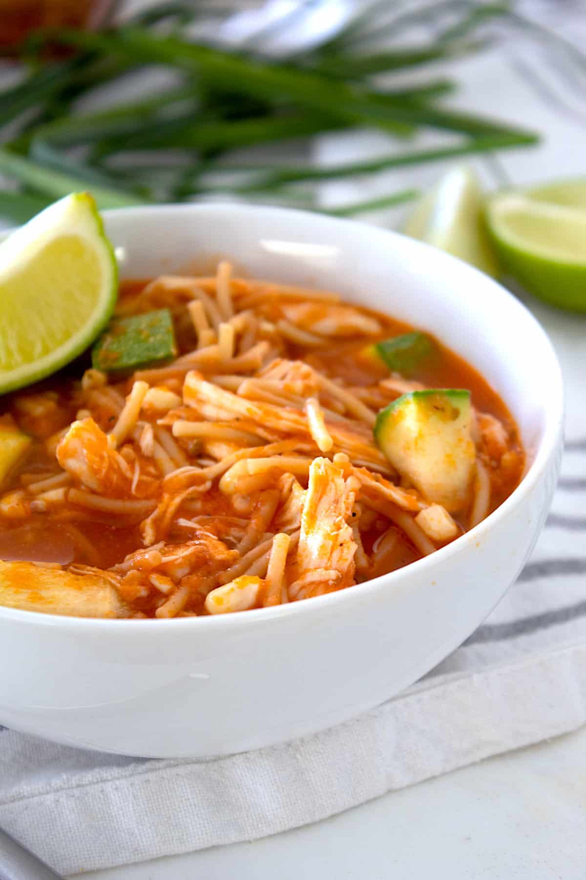 bowl of soap de fideo with lime garnish