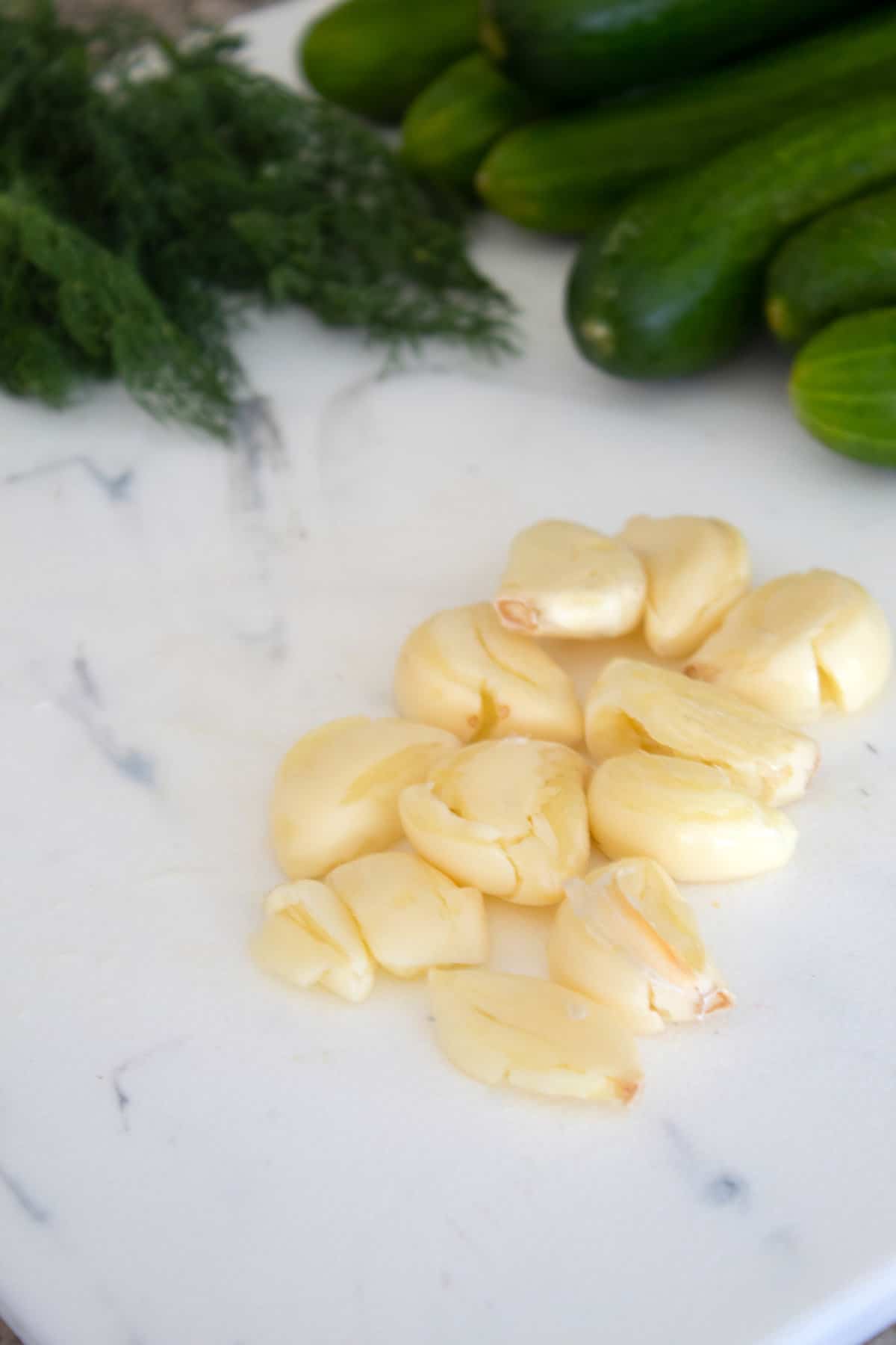 smashed garlic on a cutting board