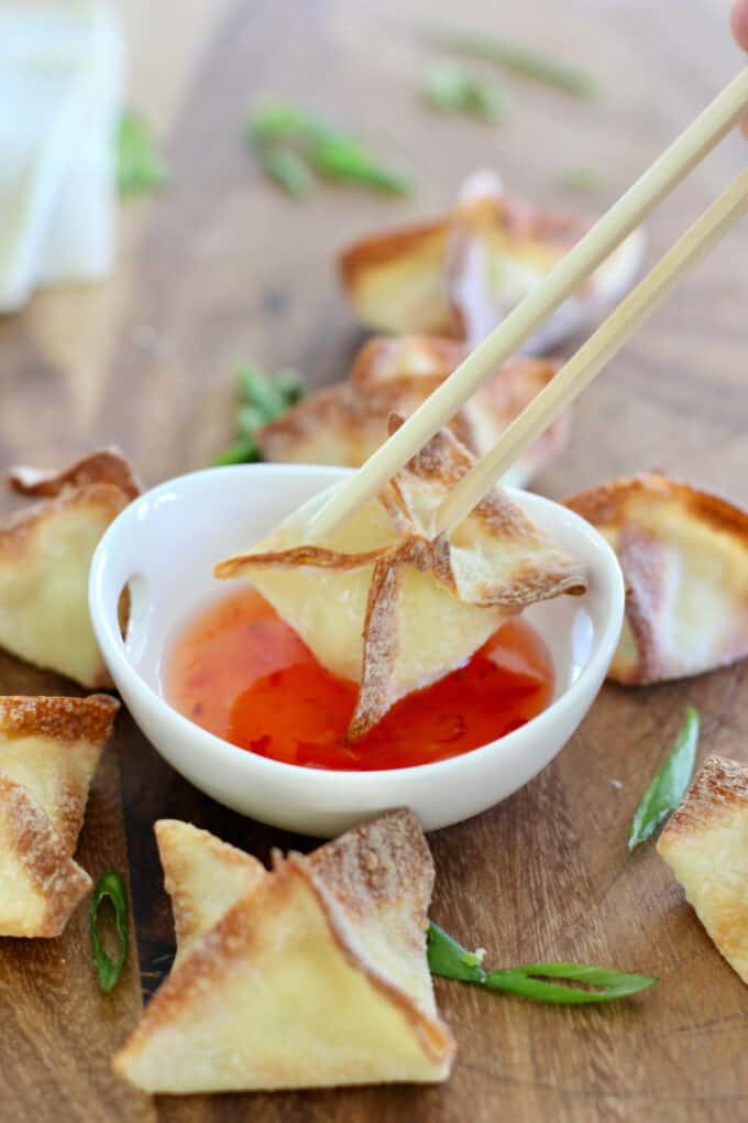 stuffed wontons being served with chopsticks