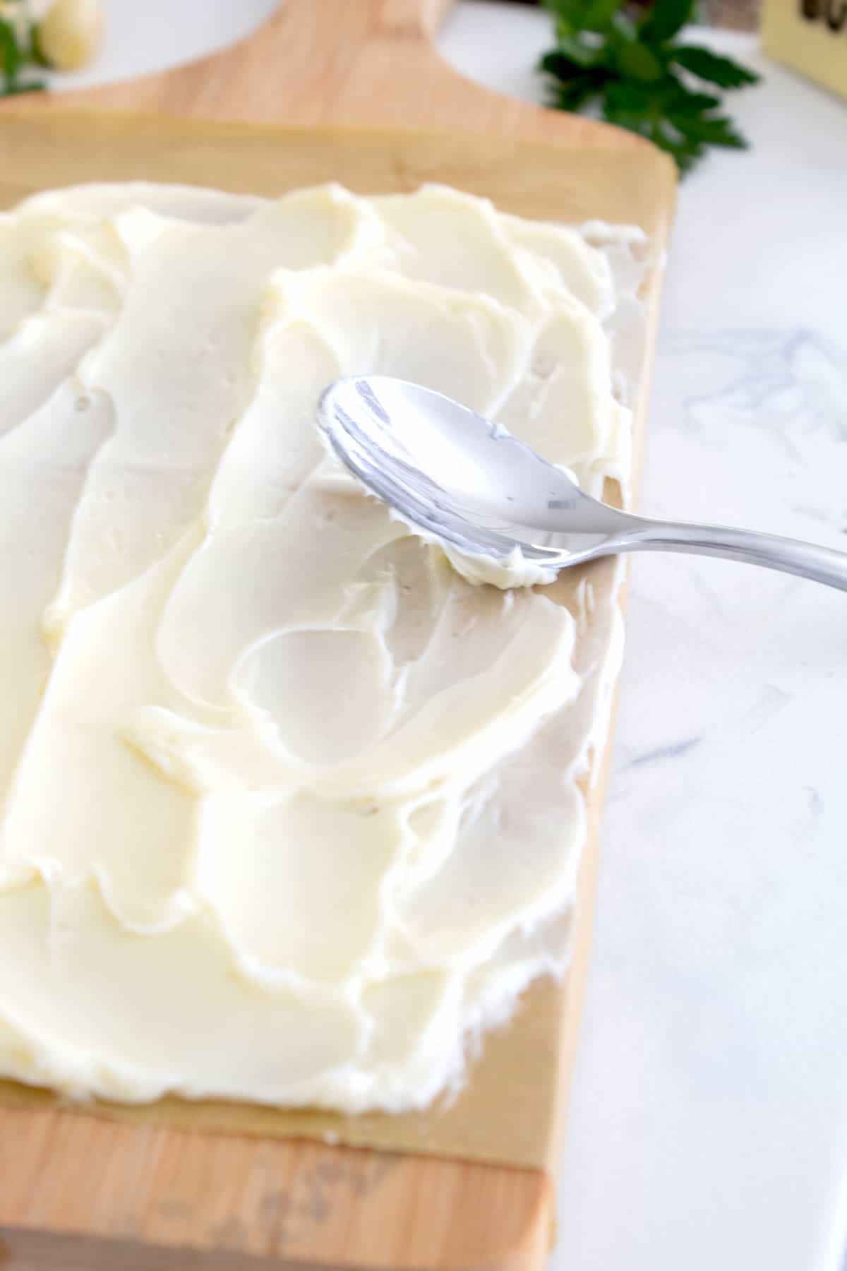 softened butter on a wooden plank