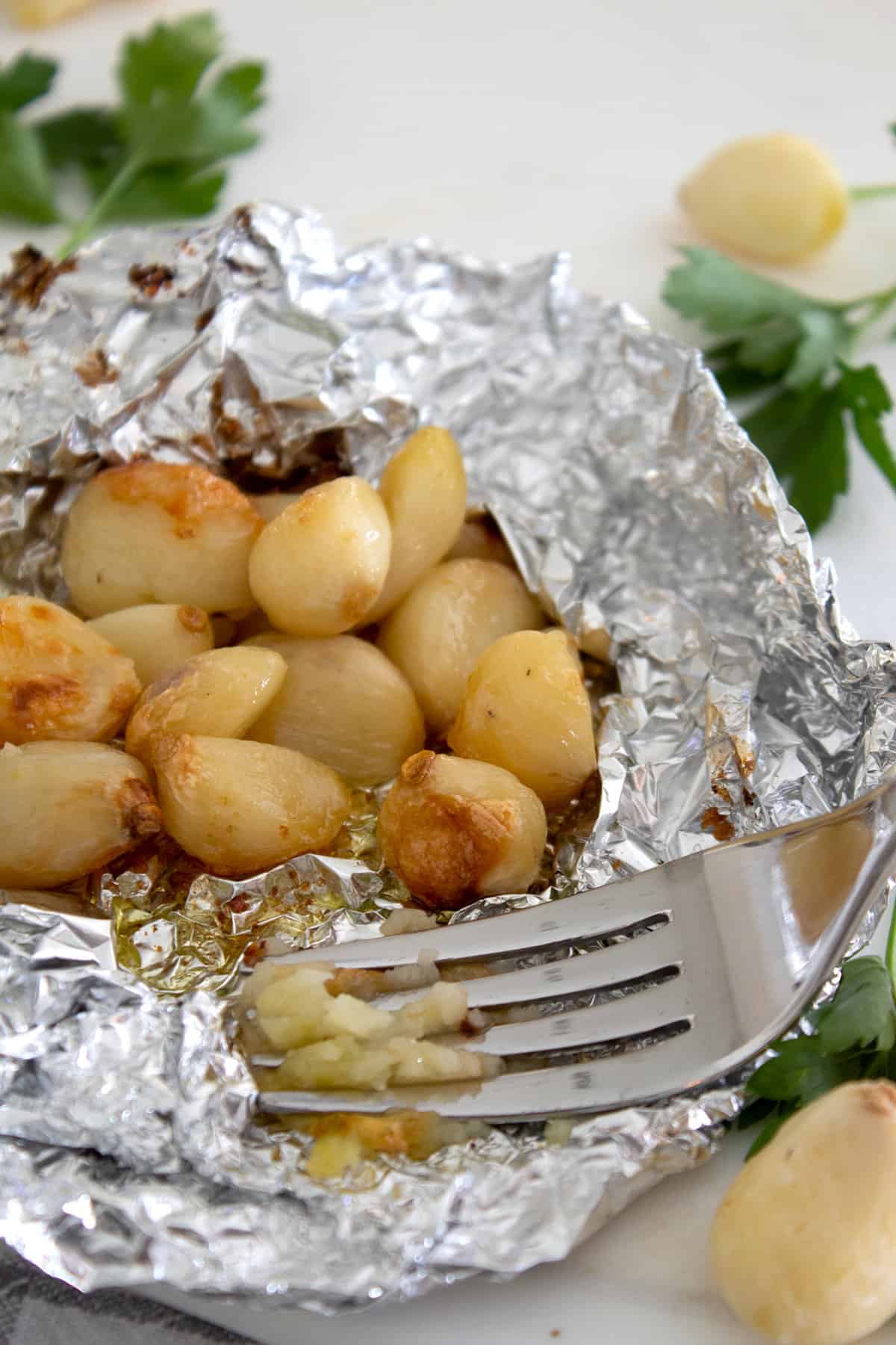 roasted garlic in a foil tin